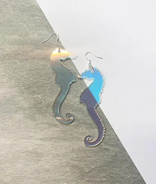 Seahorse shaped earrings in iridescent acrylic.